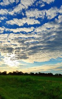 Scenic view of field against sky at sunset
