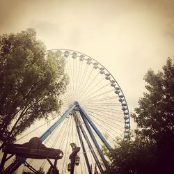 Low angle view of ferris wheel against sky