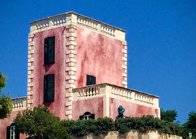 Low angle view of building against blue sky