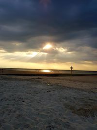 Scenic view of beach against sky during sunset