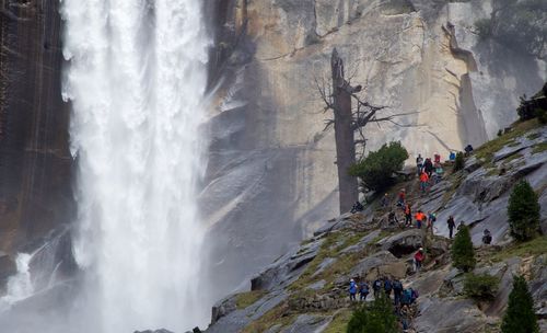 Hikers walking on mountain against vernal fall