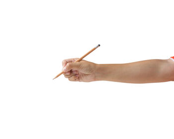 Hand holding cigarette against white background