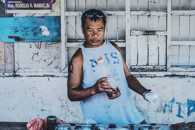 Woman standing by wall