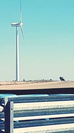 Wind turbine against clear blue sky