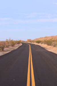 Empty road against clear sky