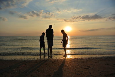 People on beach during sunset