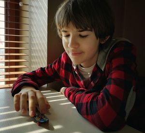 Portrait of boy sitting at home