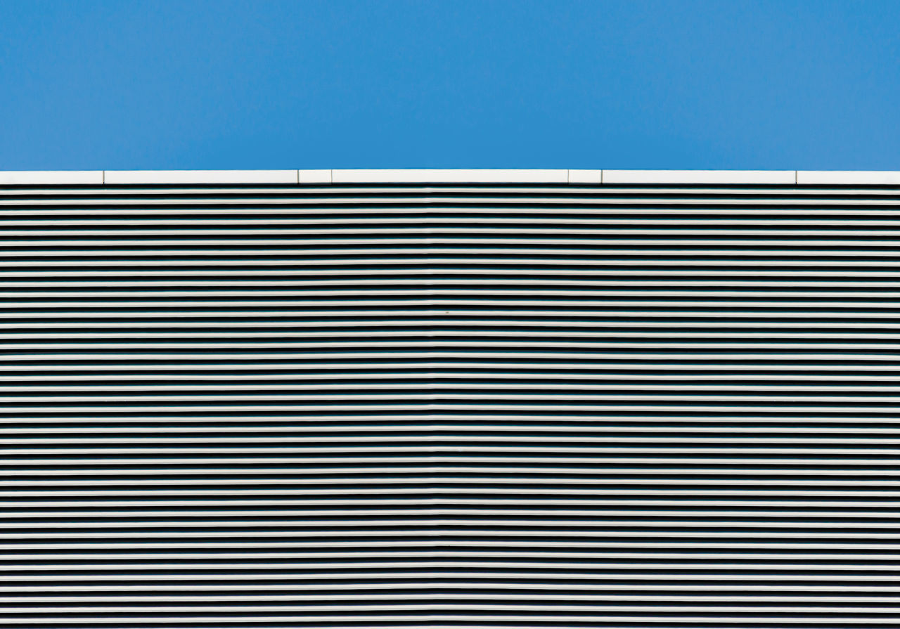 CLOSE-UP OF BUILDING AGAINST BLUE SKY