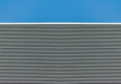 Close-up of wall against blue sky