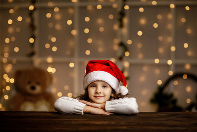 Portrait of cute girl sitting on table