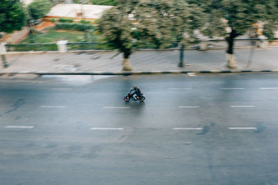 People riding motorcycle on road