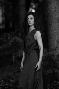 Portrait of young woman standing on field