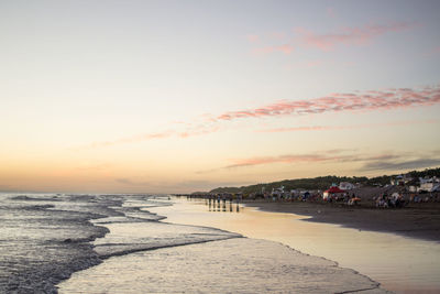 Scenic view of beach against sky during sunset
