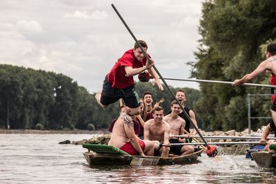 Men sitting on boat in river