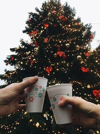 People holding christmas tree