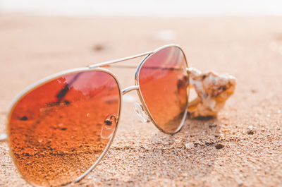 Close up of sunglasses on sand