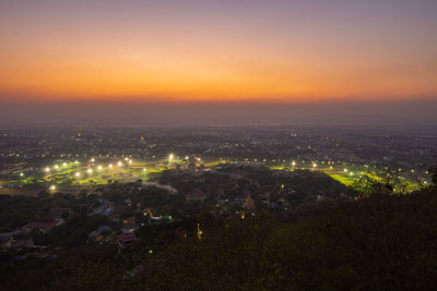 High angle view of illuminated buildings in city at night