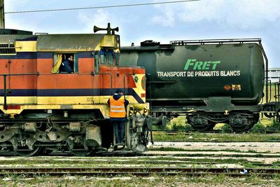 Train on railroad tracks against sky