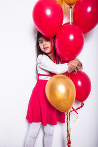 Portrait of a girl holding balloons