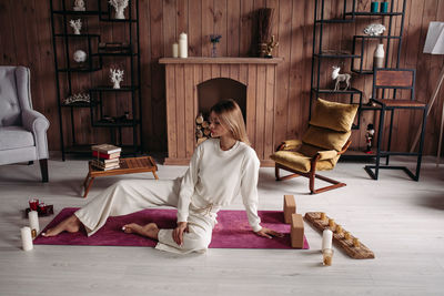 Woman sitting on sofa at home