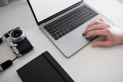 High angle view of person using laptop on table