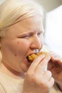 Close-up portrait of woman eating