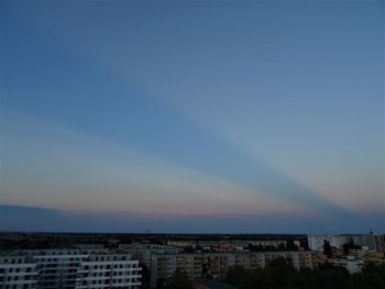 Aerial view of buildings in city against clear sky