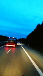 Cars on road at dusk