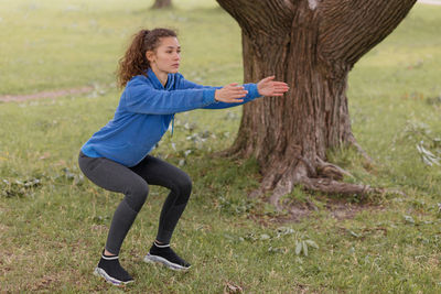 A european woman does sports in a park or a public place. warm-up and jogging in the fresh air