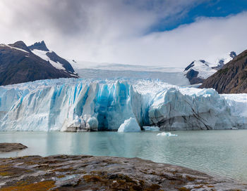 Global warming - transformation of a glacier into a pool of water. impact of rising temperatures.