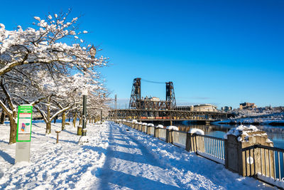 Snow covered city against blue sky