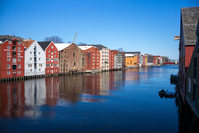 Panoramic view of houses against clear blue sky