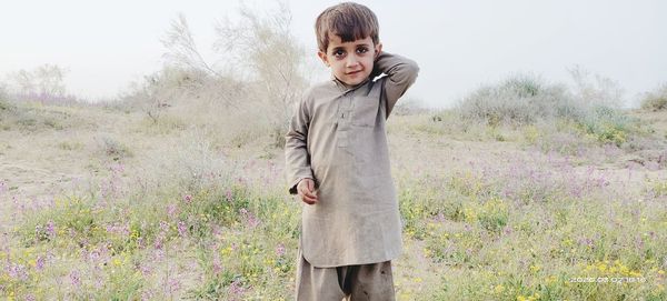 Full length of boy standing on field