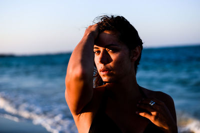 Close-up portrait of woman standing at beach