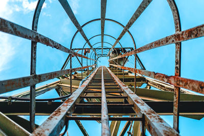 Directly below shot of rusty ladder on tower