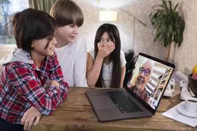 Young woman using laptop on table