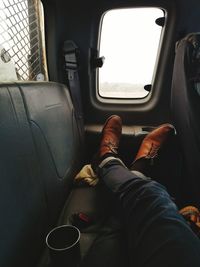 Low section of man sitting in car