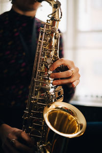 Midsection of man playing guitar