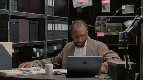 Young man using laptop at office