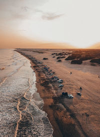 High angle view of sea shore against sky during sunset