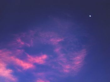 Low angle view of moon in blue sky