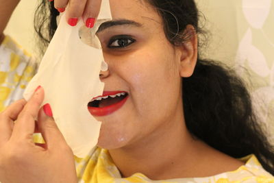 Close-up of woman with facial mask at home