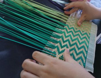 High angle view of person weaving on table
