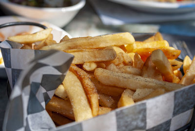 Close-up of burger and fries in plate on table