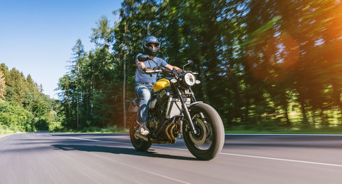 Man riding motorcycle on road