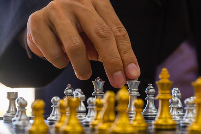 Low section of person playing with chess