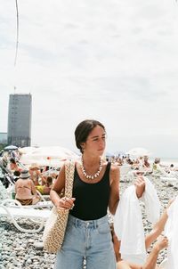 Portrait of young woman standing at beach