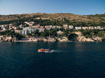 Scenic view of sea and buildings against sky