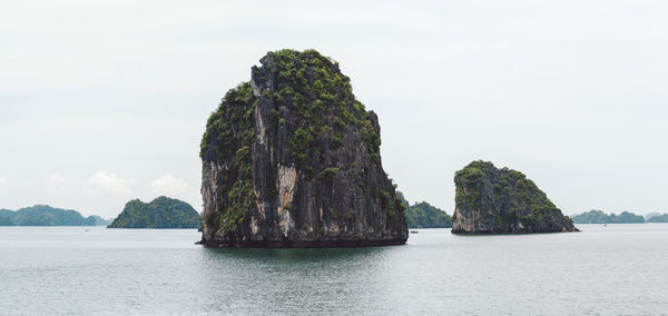 Panoramic view of rock formation in sea against sky