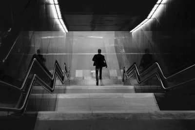 Rear view of man moving down steps